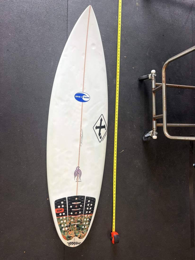 Xanadu · 5' 9" — Deck, nose up and measuring tape on right