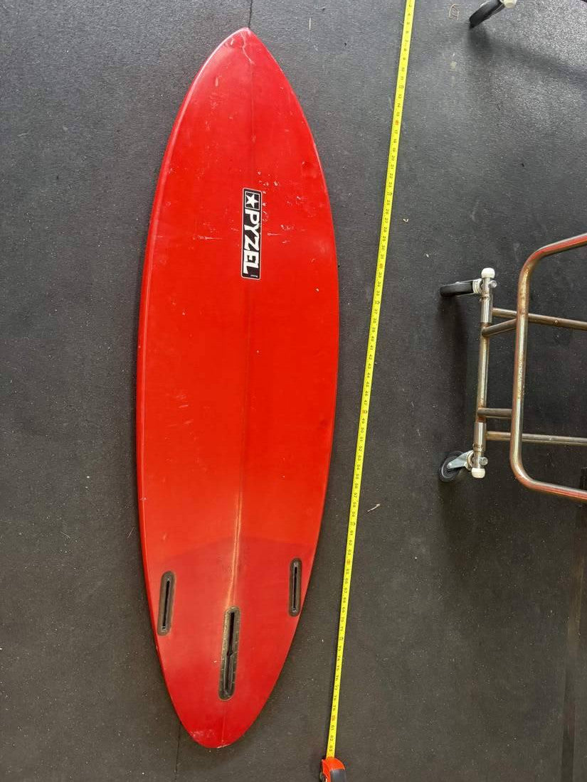 Pyzel · 5' — Bottom, nose up and measuring tape on right