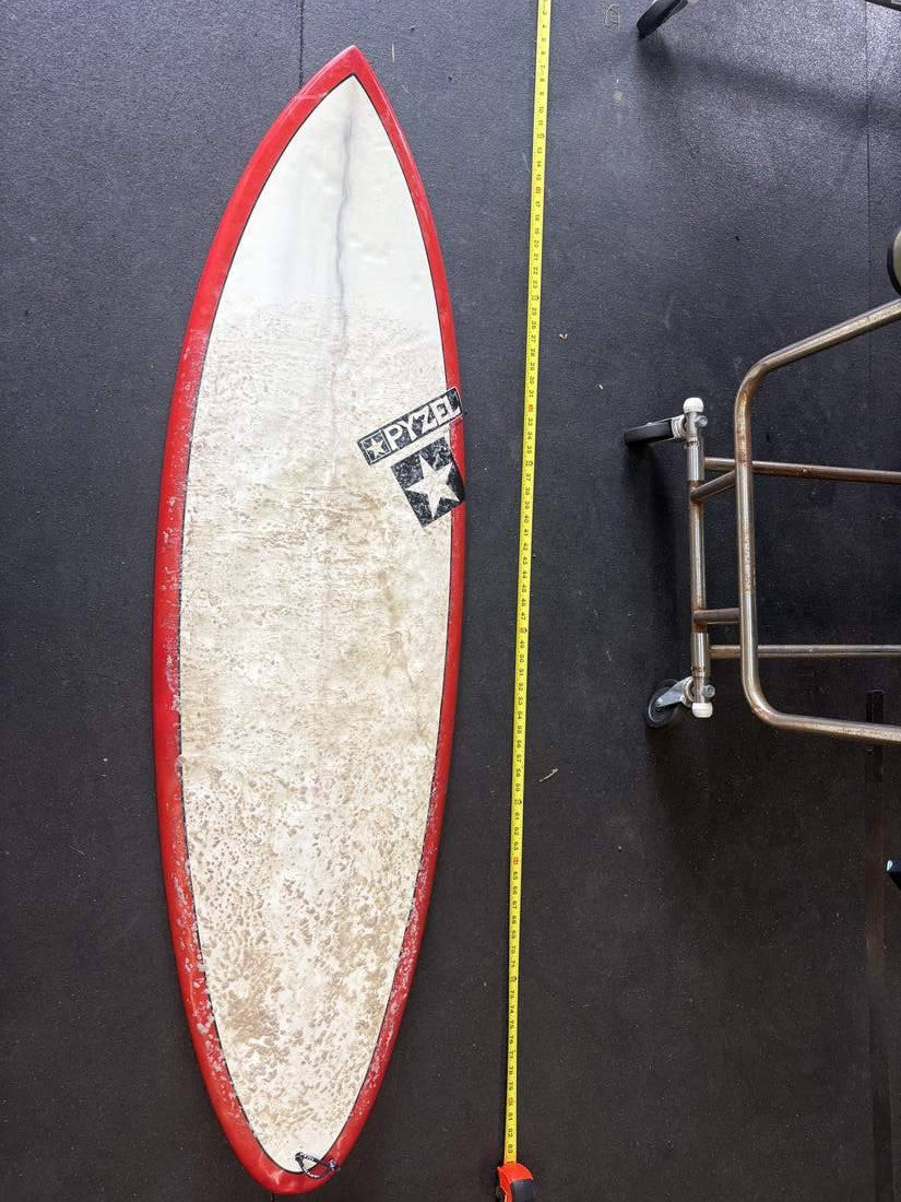 Pyzel · 5' — Deck, nose up and measuring tape on right