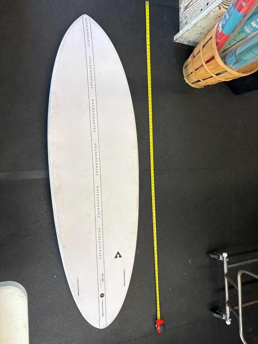 Hayden Shapes · 6' 11" — Bottom, nose up and tape on right