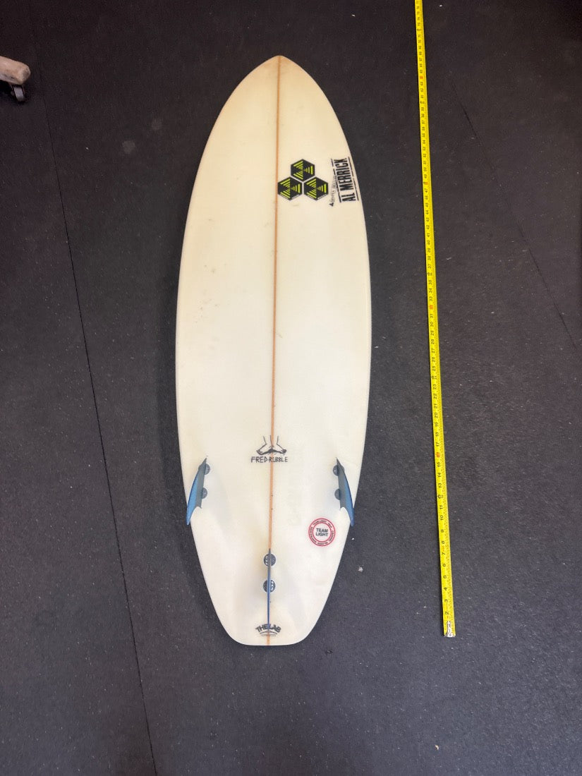 Al Merrick · 5'8" bottom view, nose up, yellow measuring tape on right