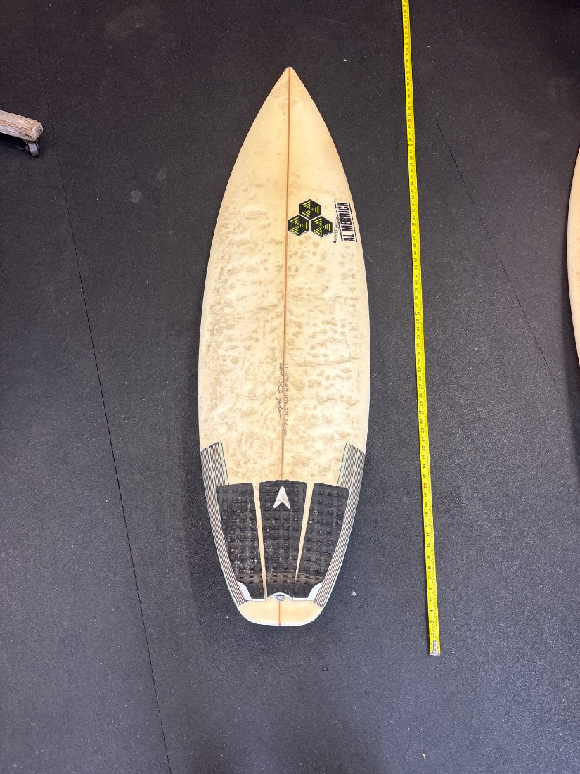 Al Merrick · 5'8" deck view, nose up, yellow measuring tape on right